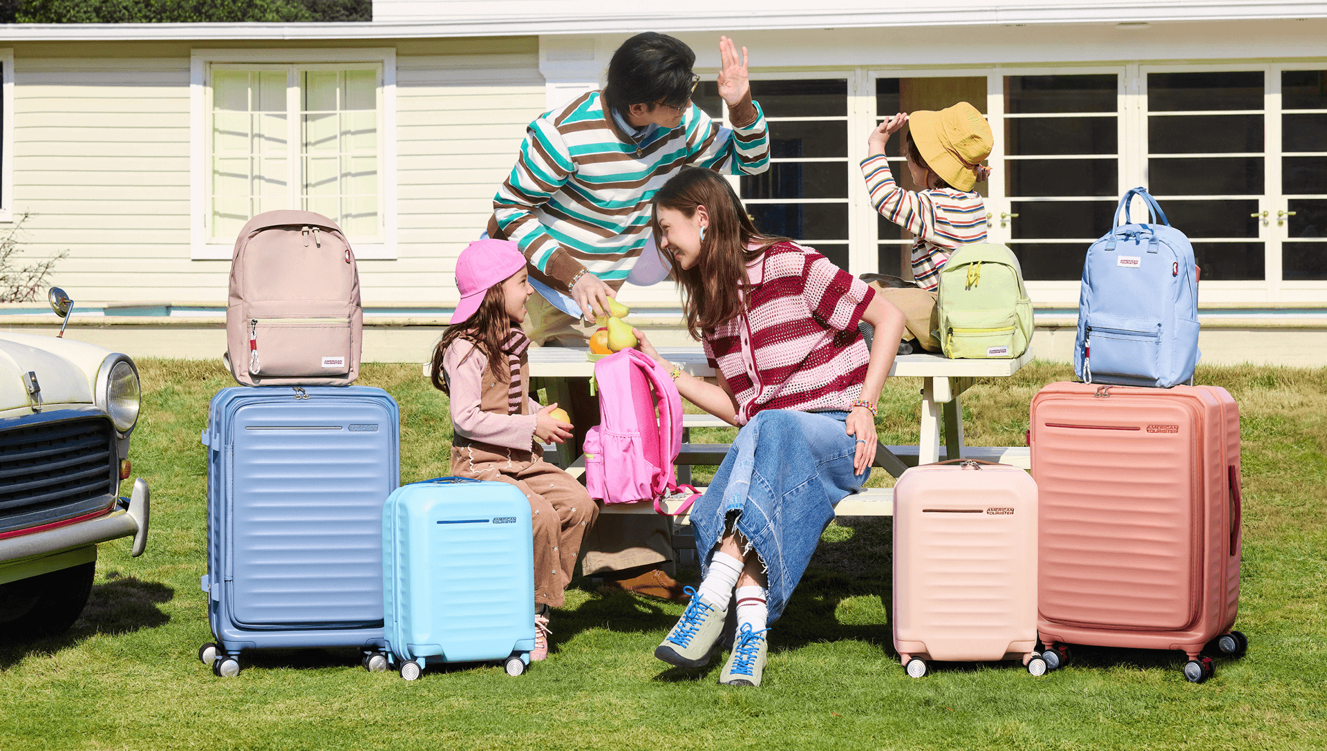 Three travellers with American Tourister luggage by a pool