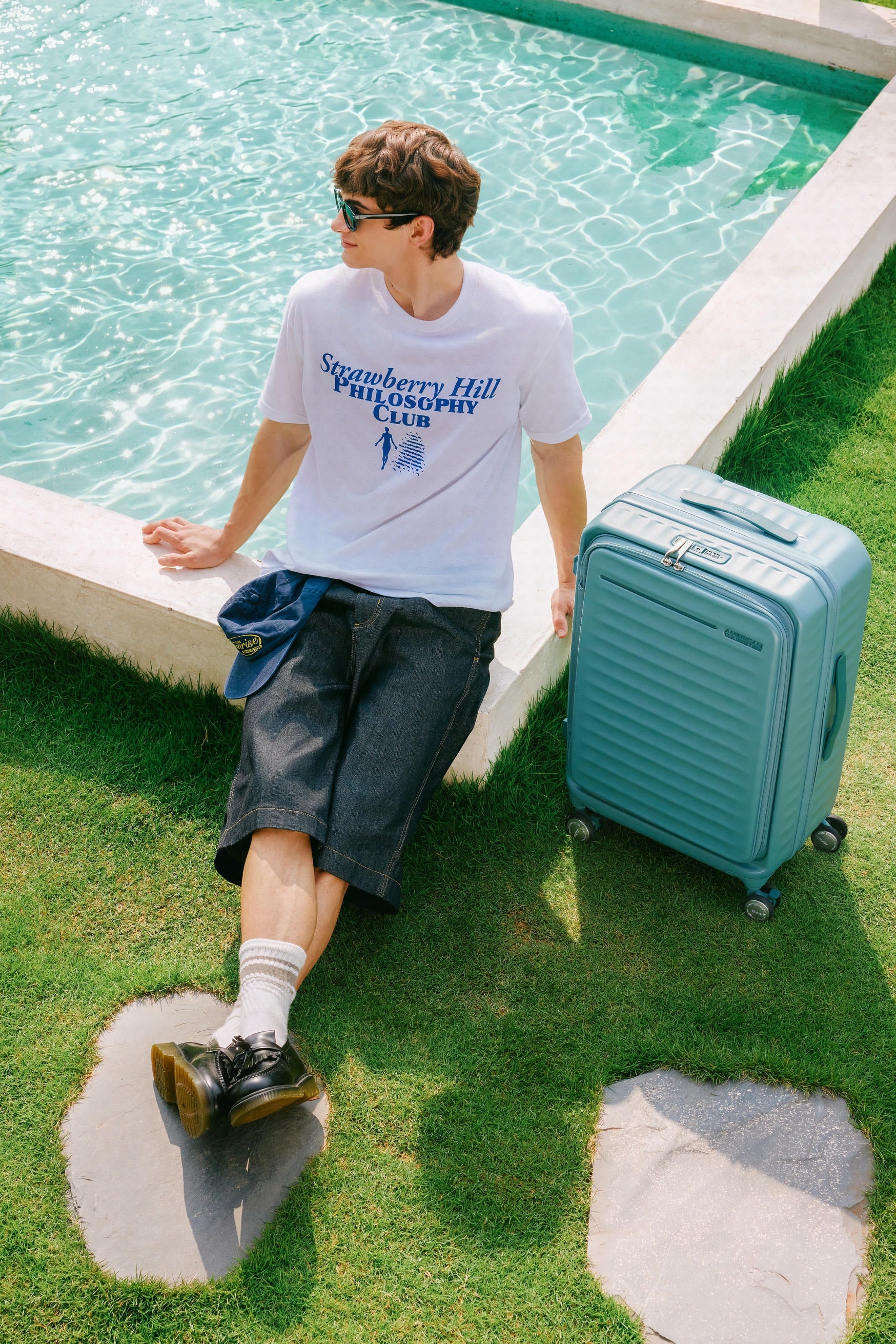 Traveller stepping with a teal suitcase